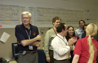Dr. Louis D'Amario (left) and part of the navigation team celebrate their bulls-eye at Mars